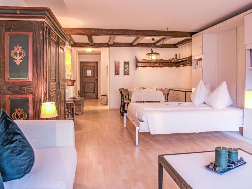 a hotel room with two beds and a couch at Apartment Residenz Surlej 6 by Interhome in St. Moritz
