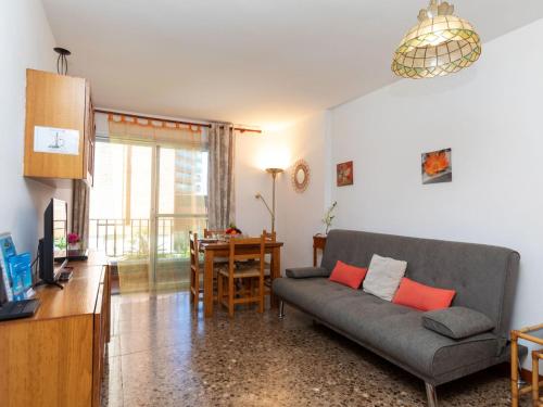 a living room with a couch and a table at Apartment Las Americas by Interhome in Lloret de Mar