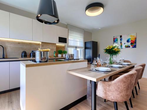 a kitchen with a table and chairs in a kitchen at Apartment Marina - NVG115 by Interhome in Novigrad Istria