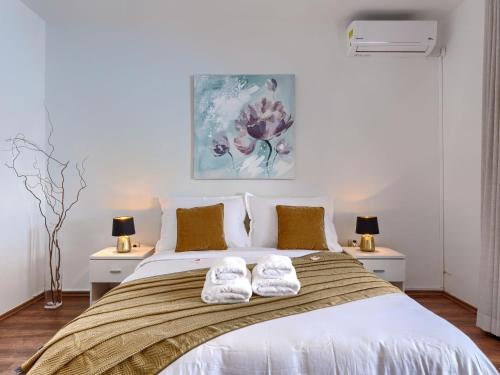 a bedroom with a bed with two white towels on it at Apartment Marina - NVG115 by Interhome in Novigrad Istria