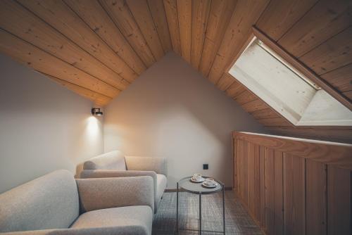 a living room with two chairs and a window at Alliey & Spa Piscine Appart-hôtel Serre chevalier in Le Monêtier-les-Bains