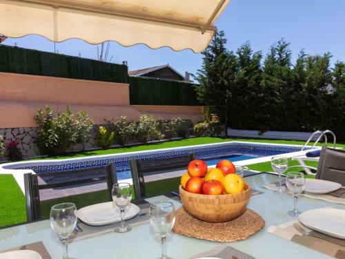 a table with a bowl of fruit on top of it at Holiday Home Emballia by Interhome in Caulés