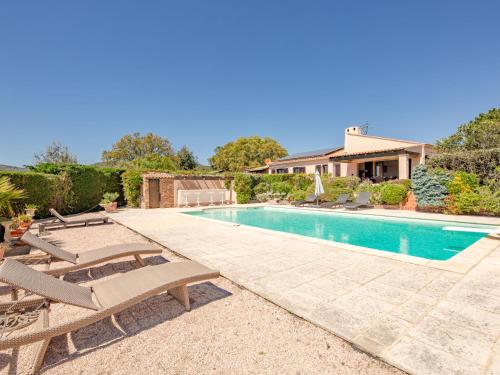 une piscine avec des chaises longues et une maison dans l'établissement Holiday Home Le Mas d'Olive by Interhome, à Grimaud