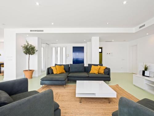 a living room with a couch and a table at Villa Megin by Interhome in Cumbre del Sol