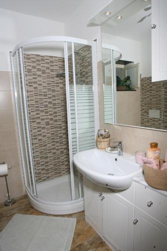 a white bathroom with a shower and a sink at CASA ALESSIA NEL VERDE con WI-FI in Ageno