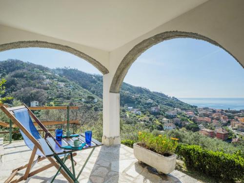 a room with a table and a chair on a balcony at Holiday Home Sorvegallo by Interhome in Moneglia