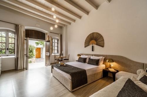 a bedroom with a bed and a couch at Lithinon Luxury Suites with Free Parking in Chania Town