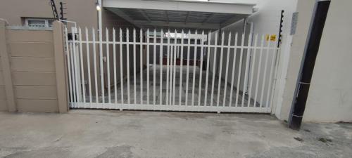 a white gate in a garage with a door at Lasai Accommodation in Worcester