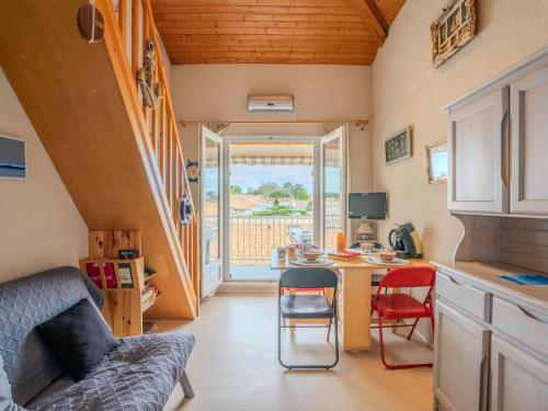 a small kitchen with a table and chairs in a room at Apartment Les Jardins de l'Océan-42 by Interhome in Vaux-sur-Mer