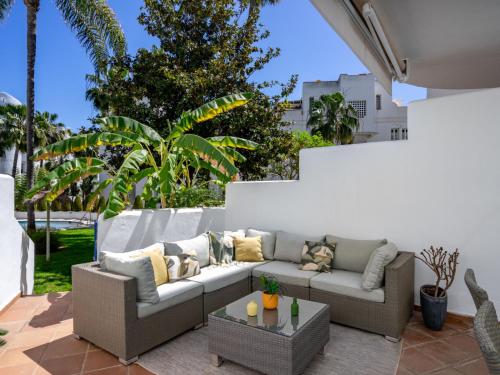 a living room with a couch on a patio at Apartment Marbella Real by Interhome in Marbella