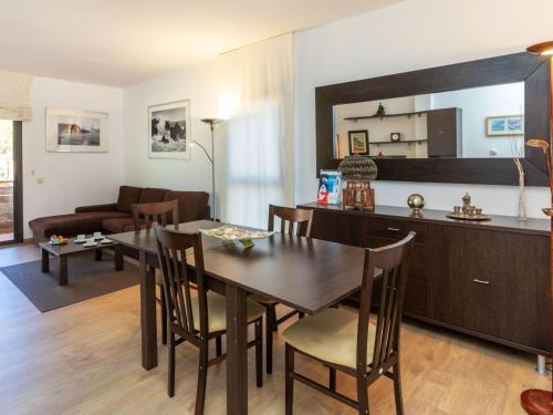 a kitchen and living room with a table and a dining room at Apartment Lloret Garden by Interhome in Lloret de Mar