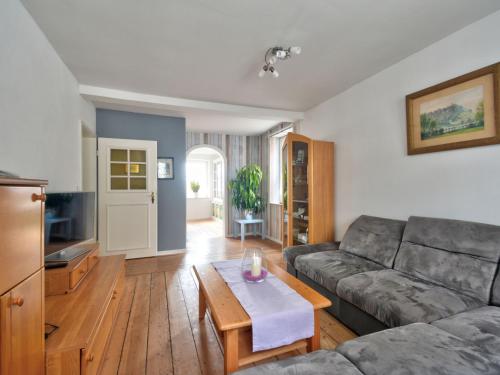 a living room with a couch and a table at Apartment Mönkemeierhof by Interhome in Schieder-Schwalenberg