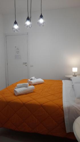 a bedroom with a bed with two towels on it at Guest House Aio Sardegna in Cagliari