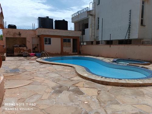a swimming pool on top of a building at Elegant furnished rooms with swimming pool in Nyali in Mombasa