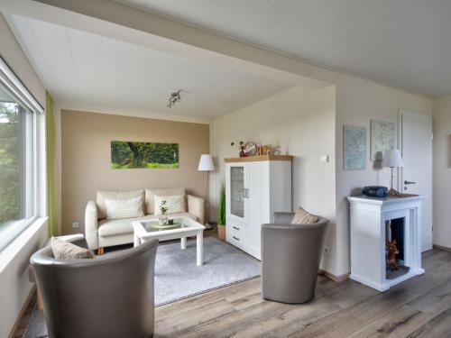 a living room with a couch and a table at Holiday Home Merle by Interhome in Vörden