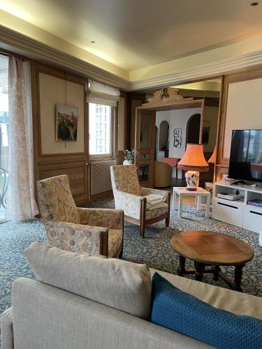 a living room with a couch and a tv at Maison Galland in Lapalisse