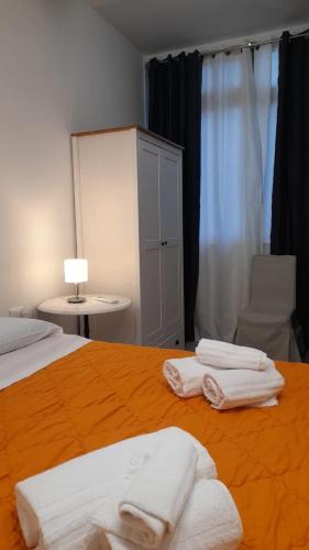 a bedroom with a bed with white towels on it at Guest House Aio Sardegna in Cagliari