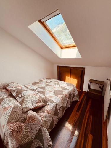 a bedroom with a bed and a skylight at MartinVidal 3 in Luarca