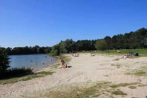 a group of people on a beach near a body of water at Ferienhaus Kalle 55180 in Detern