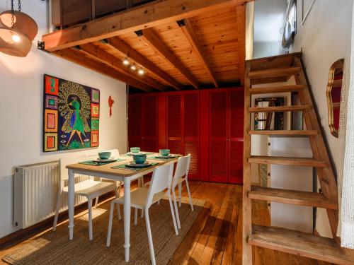 a dining room with a table and chairs and a ladder at Casa Aletta - Old Town Apt. in Rhodes Town