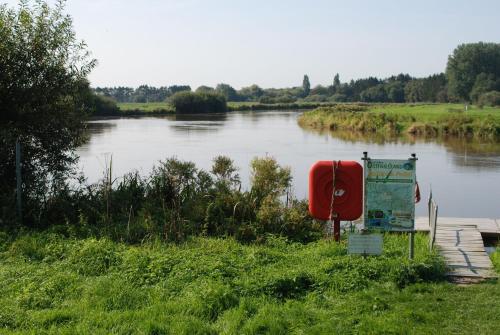 a view of a river with a sign next to it at Ferienhaus Kalle 55180 in Detern