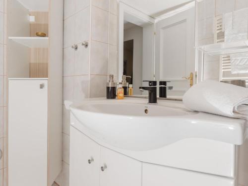 a white bathroom with a sink and a mirror at Apartment The Bubble by Interhome in Bad Gastein
