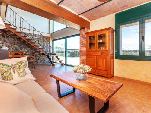 a living room with a couch and a table at Holiday Home Can Borni by Interhome in Vidreres