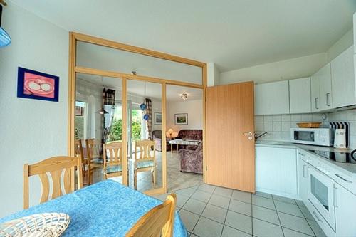 a kitchen and living room with a table in a room at Luv in Zingst