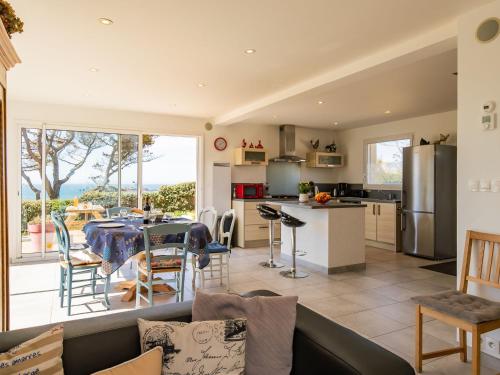 a kitchen and living room with a table and chairs at Holiday Home La maison de Toul an Dour by Interhome in Plouarzel