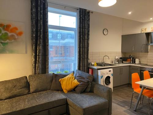 a living room with a couch and a kitchen at Mia's Place Three Apartments in One in Chester