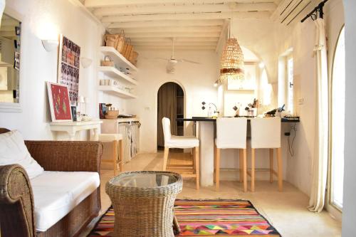 a kitchen and living room with a table and chairs at Dar Shams in Erriadh