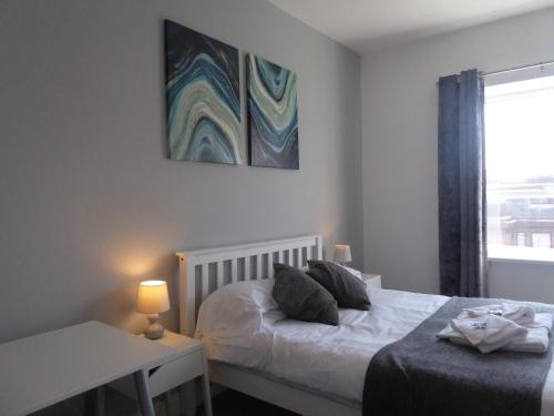 a bedroom with a bed and a table and a window at Mia's Place Three Apartments in One in Chester
