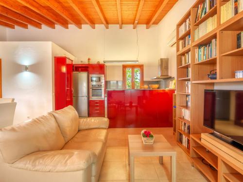 a living room with a couch and red cabinets at Holiday Home Can Caragoli by Interhome in Alcudia