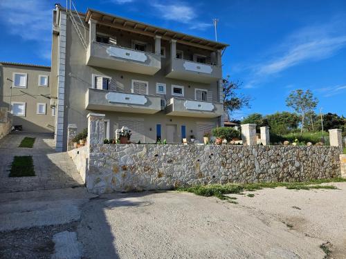 a building with a stone wall next to a building at GREY LUXURY HOUSE in Ýpsos