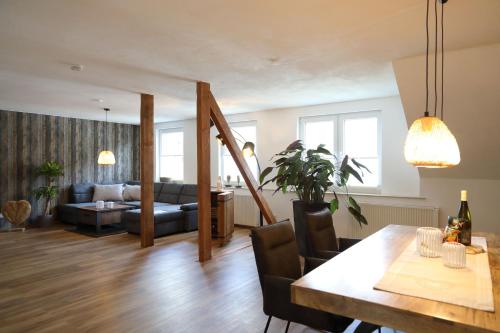 a living room with a table and a couch at Ferienwohnung Moselallee 5 Sterne in Moselkern