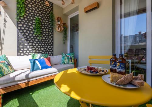 a yellow coffee table with a plate of food on it at Torremolinos Centro terraza wifi parking ascensor a la playa a 5 min in Torremolinos