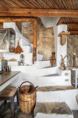 a room with white stairs and a basket at Fos of Serifos in Serifos Chora