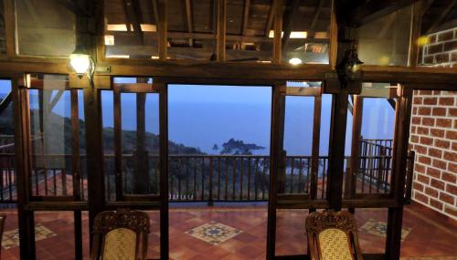 a view from the inside of a room with a balcony at Verandah By The Sea in Vengurla