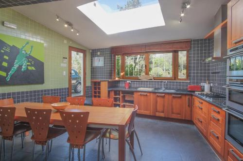 a kitchen with a wooden table and a dining room at Casa Montaza 4 Bedroom Villa with private pool in Lagos in Lagos