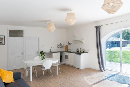 a kitchen and living room with a table and chairs at Long Range 1, Henham Park Nr Southwold in Beccles