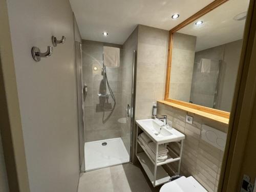 a bathroom with a shower and a sink at Hôtel le Bout du Parc in Versailles