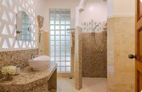 a bathroom with a sink and a shower at Palmhill Villa in Boracay