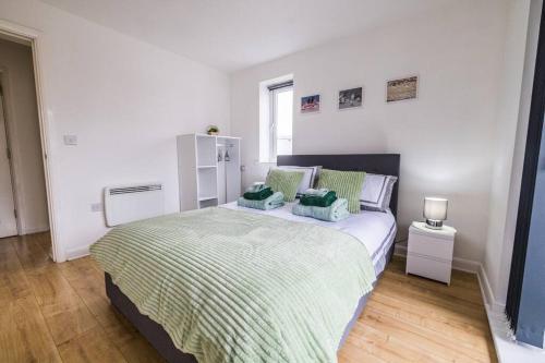 a bedroom with a bed with two pillows on it at Modern 2 Bed Flat Free Parking City Centre in Spon End