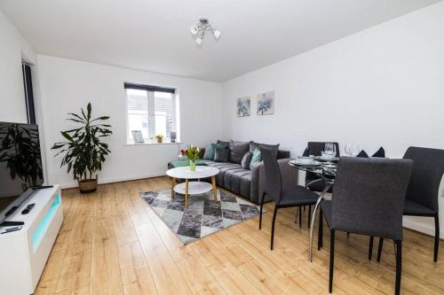 a living room with a couch and a table at Modern 2 Bed Flat Free Parking City Centre in Spon End