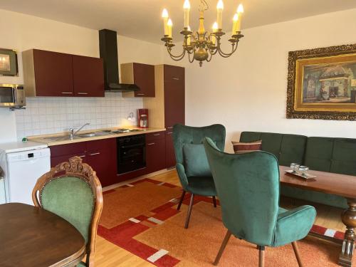 a kitchen with a table and chairs and a dining room at Apartment Neuensien 11a in Seedorf