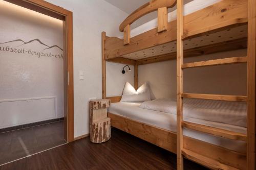 a bedroom with two bunk beds and a doorway at ALPENAPART LADIS ehemals Alpenapart Alexander in Ladis