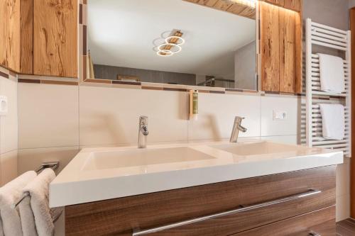 a bathroom with a sink and a mirror at ALPENAPART LADIS ehemals Alpenapart Alexander in Ladis