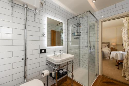 a bathroom with a sink and a shower at Grange Manor in Grange Over Sands