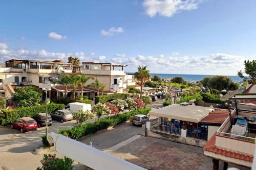a view of a town with cars parked in a parking lot at Appartamento Sun and Sea in Campora San Giovanni