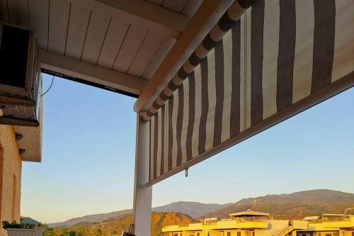 a view of a building with awning and mountains at Appartamento Sun and Sea in Campora San Giovanni